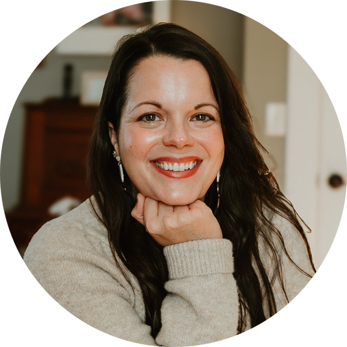 Headshot of Miranda Fredrick, Licensed Clinical Social Worker and therapist, smiling warmly, wearing a cozy casual outfit, with a friendly homey background.